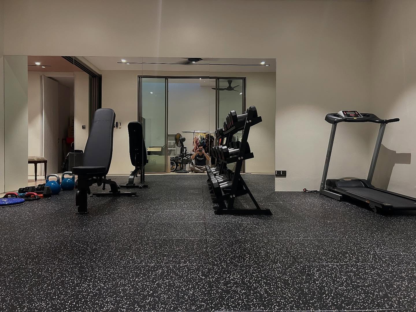 Gym setup with dumbbells and bench.