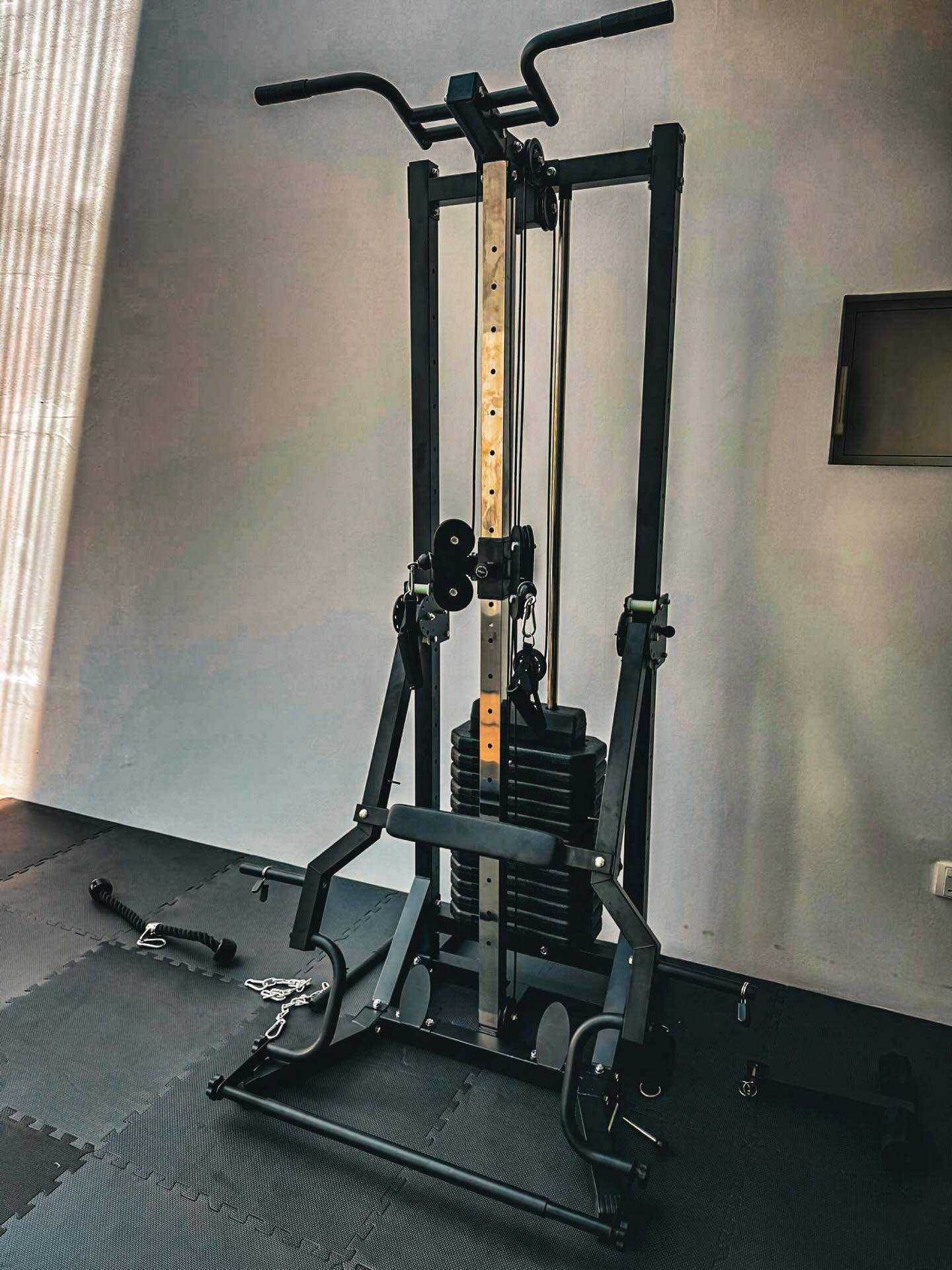 Space saving cable machine with lat pull down, low row, fly, leverage gym